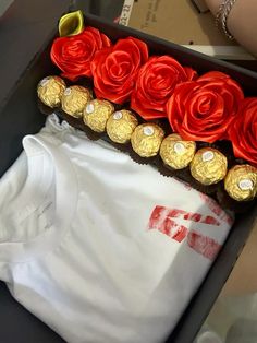 a box filled with red and gold roses