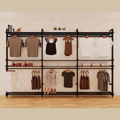 a rack with clothes and shoes hanging on the wall next to a wooden floor in front of a white wall