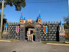 two men standing in front of a castle entrance