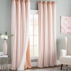 the curtains are hanging in front of the window, and one is pink with white trim