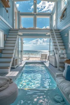 an indoor swimming pool in the middle of a room with stairs leading up to it