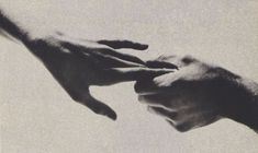 two hands reaching out towards each other in black and white, against a pale background