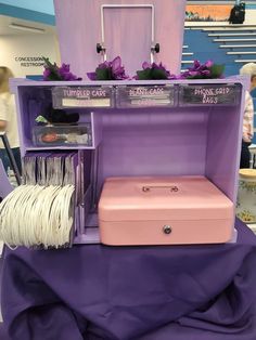 a pink suitcase sitting on top of a purple table