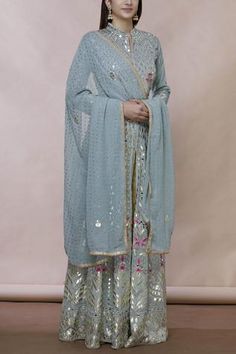 Grey floor-length anarkali with all over gota applique floral motifs. Comes with embellished dupatta.
Components:2
Gota, mirror embroidered
Neckline:Mandarin collar
Sleeve Length:Full
Fabric:Georgette
Color:Grey
Split neckline
Front slit
Contrast detail
Dupatta with lace border
Note: Pants worn by the model is for styling purpose only - Aza Fashions Lehenga Bollywood, Anarkali With Dupatta, Embroidered Anarkali, Formal Wear Dresses, Salwar Kamiz, Floral Gown, Muslimah Fashion Outfits, Dress Indian Style, Fashionista Clothes