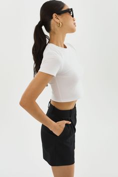 Elevate your basics with the INGA cropped t-shirt. The shortened length is perfect for a laid-back vacation atmosphere. It effortlessly pairs with various bottoms, from shorts and skirts to jeans or casual trousers, allowing you to create different looks with minimal effort. White Relaxed Fit Cropped T-shirt For Everyday, Stretch Cotton Cropped T-shirt, White Boxy Cropped T-shirt, Black Stretch Cropped T-shirt, White Stretch Cropped T-shirt, Cropped T Shirt, Casual Trousers, Crop Tshirt, Rib Knit