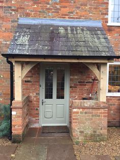 an old brick building with a green door