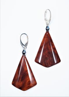 a pair of wooden earrings on a white background