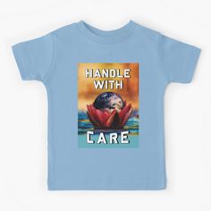 a blue t - shirt with the words handle with care in front of an image of a