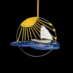 a birdcage with a sailboat in the ocean on it's side