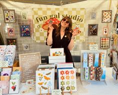 a woman standing in front of a table with cards and magnets on top of it