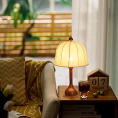 a lamp sitting on top of a table next to a couch