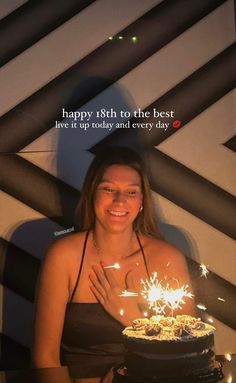 a woman holding a cake with sparklers on it and the caption happy 80th to the best