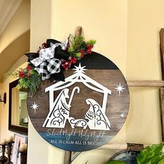 a wooden sign with a nativity scene on it