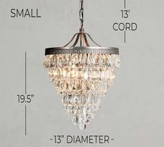 a chandelier hanging from the ceiling with measurements