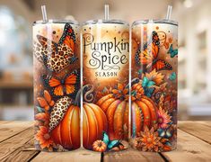 three pumpkins and butterflies are painted on the side of two tumblers, one is orange