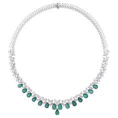 Elevate your style with the luxurious charm of this Pear Zambian Emerald Gemstone Choker Necklace, accented by shimmering Diamonds and meticulously crafted in 14k White Gold. This exquisite piece of jewelry is a celebration of sophistication and natural beauty, designed to grace your neckline with unparalleled elegance and allure. Item Code :- SEN-51270 (14k) Gross Wt. :- 29.77 gm 14k Solid White Gold Wt. :- 24.60 gm Natural Diamond Wt. :- 12.39 Ct. ( AVERAGE DIAMOND CLARITY SI1-SI2 & COLOR H-I Gemstone Choker Necklace, Gemstone Choker, Necklace Diamond, Zambian Emerald, Colored Stone, Emerald Necklace, Large Gift, Antique Necklace, White Gold Jewelry