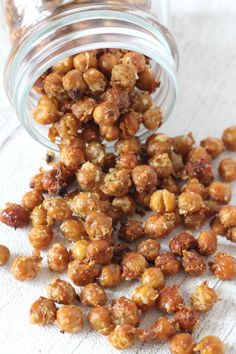 a glass jar filled with nuts sitting on top of a table