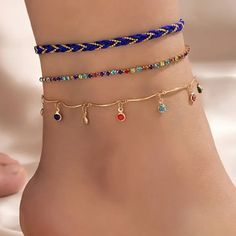 Fashionable 3 Piece Royal Blue Gold Toned Anklet Set. The First Anklet Is A Royal Blue Rope With Gold Toned Ball Chain Intwined Throughout. The Second Anklet Is A Gold Toned Multi Colored Crystal Tennis Style Anklet. The Third Anklet Is A Gold Toned Anklet With Dangling Multi Colored Crystals Connected By Curved Gold Toned Bars. Wear Them Together Or Separately To Change Your Look. The Rope Anklet Is Approx. 8” With A 2” Extension The Crystal Tennis Style Anklet Is Approx. 9” With A 2” Extension Blue Beach Anklets, Blue Bohemian Anklets For Party, Adjustable Blue Anklets For Party, Rope Anklet, Crystal Anklet, Tennis Style, Royal Blue And Gold, Ankle Chain, Color Crystal