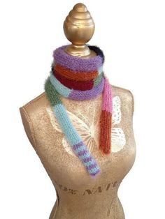 a mannequin wearing a multicolored knitted scarf