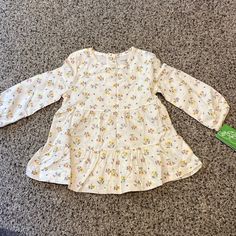 Nwt Simple Joy By Carters Floral Top Playful Long Sleeve Cream Tops, Cream Tops For Spring Playtime, Cute Cream Playwear Top, Cute Cream Top For Playwear, Cream Tops For Spring Playwear, White Long Sleeve Playwear Dresses, White Long Sleeve Dress For Playwear, Spring Floral Print Tops For Playwear, White Tops For Fall Playwear