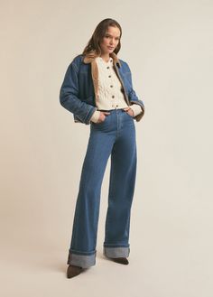 The stonewashed medium blue denim of The Bridget Crop Jacket has cool, vintage vibes thanks to the tan shearling lining, pointed collar and dropped front and back yoke. It has a slightly cropped length and features seam details and low, slanted front pockets for true retro vibes. 91% Cotton, 9% Recycled Cotton Zo is 5'10" wearing size small. Retro Denim Blue Jacket For Winter, Denim Outerwear With Corduroy Collar For Fall, Fall Denim Outerwear With Corduroy Collar, Retro Medium Wash Outerwear For Winter, Retro Medium Wash Winter Outerwear, Retro Medium Wash Outerwear For Fall, Retro Denim Blue Outerwear For Fall, Vintage Denim Jeans For Winter, Denim Blue Cropped Denim Jacket For Winter