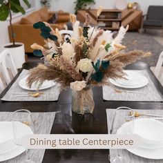 a dining table with place settings and flowers in a vase on the centerpiece that says dining table centerpiece