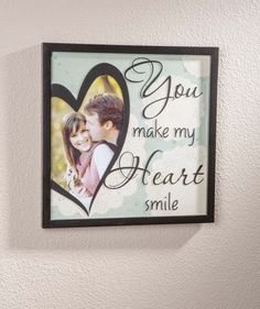 a couple's heart with the words you make my heart smile hanging on a wall