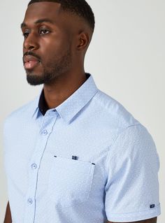 Smiling is easy in this stretch premium cotton short sleeve shirts. The geometric pattern stands out without being busy; while the 7DIAMONDS signature details elevate the style. Details Model is 6'1" and wears a size medium. Care: Machine wash cold on delicate cycle, low tumble dry, do not iron Composition: 50% Cotton/ 46% Polyester/ 4% Spandex Light Blue Casual Shirt For Semi-formal Occasions, Light Blue Short Sleeve Shirt For Business Casual, Denim Accessories, Short Sleeve Shirts, Short Sleeve Button Up, Short Sleeve Button, Rhodes, Lifestyle Brands, Cotton Shorts