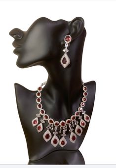 Enhance your special occasion look with our CZ American Diamond Necklace. Perfect for weddings, parties, or as a gift. Its red stones add a touch of elegance to any outfit, such as a saree, gown, or lehanga. Elevate your style with this stunning accessory. This jewellery set includes a necklace and matching earrings. Jewellery Care- Keep the jewellery dry, avoid contact with perfumes and water. American Diamond Necklaces, Saree Gown, Bridal Choker, Red Stones, A Necklace, Jewellery Set, American Diamond, Red Stone, Ring Finger