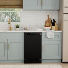 a black dishwasher sitting in the middle of a kitchen