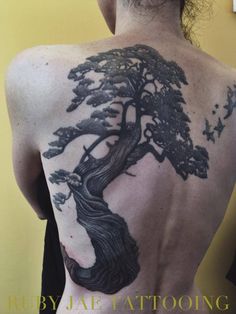 a man with a tree tattoo on his back