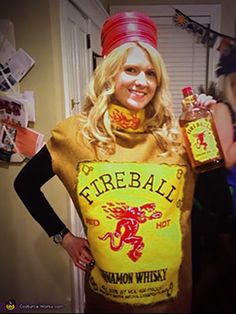 a woman dressed in a costume holding two bottles of fireball rummawn whisk