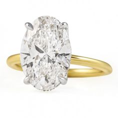 an oval cut diamond in a yellow gold ring