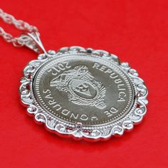 "You are looking at a gorgeous solid 925 sterling silver necklace, set with an authentic 2012 Honduras 20 Centavos BU Uncirculated Coin - Portrait of Chief Lempira. The coin is 18 mm diameter, and set with backside 4-prong. The pendant is made of solid 925 sterling silver, sized about 1.16\"(29 mm) x 0.9\"(23 mm). It comes with a 18\" solid 925 sterling silver chain, and also a gift box. I hope you end up with one of these beautiful coin necklaces. This necklace will be great for gift, investmen Silver Sterling Silver Coin Necklace As Gift, Silver Coin Necklace With Round Pendant As Gift, Silver Pendant Coin Necklace Gift, Sterling Silver Coin Necklace For Anniversary, Collectible Sterling Silver Coin Necklace With Round Pendant, Silver Coin Pendant Necklace For Anniversary, Silver Round Coin Necklace For Anniversary, Sterling Silver Coin Necklace With Round Pendant For Anniversary, Silver Coin Necklace With Polished Finish As Gift