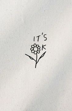 it's ok written on the back of a white t - shirt with a flower