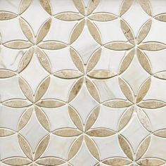 a close up view of a white and gold tile wall with circles on the side