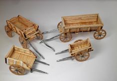 four miniature wooden wagons with wheels on white background