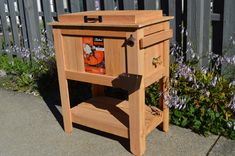 a small wooden cabinet sitting on the sidewalk