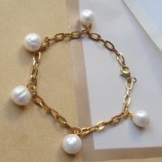 This elegant gold paperclip pearl bracelet combines modern paperclip chain links with dainty freshwater pearls, creating a stylish and minimalist accessory. Perfect for layering or as a thoughtful gift for her. Best Features: Gold Paperclip Chain - Trendy and modern design that pairs well with any outfit. Freshwater Pearls - Elegant, natural pearls for a classic touch. Lightweight & Comfortable - Designed for all-day wear without discomfort. Perfect for Layering - Complements other bracelets for Everyday Minimalist Pearl Bracelet With Metal, Everyday Minimalist Pearl Bracelet, Minimalist Baroque Pearl Bracelets, Minimalist Gold Metal Pearl Bracelet, Elegant Paperclip Bracelet With Pearl Chain, Gold Paperclip Bracelet With Pearl Chain As A Gift, Jewelry Layering Bracelets, Jewelry Layering, Customer Gifts