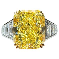 A statement in both Yellow Diamond and jewelry craftsmanship. A GIA certified center stone weighing 4.02 Carats, and flanked by 1.32 carats of High-Colorless, clean natural white diamonds. Center stone specs: GIA 4.02 carat Fancy Intense Yellow Rectangular Radiant Cut. VS2 Clarity. The GIA report is a full Fancy Color Diamond Grading Report that outlines all details of the center diamond. The side diamonds feature two rows of Step Trapezoid diamonds and close off with bullet shapes. The ring was designed and hand-crafted in New York, and is constructed of 950 Platinum (950PT) and 18 karat Yellow Gold. The bottom of the center stone was left open to allow for easy cleaning. Additional videos and photos available on request Flawless Diamond Ring, Rings Fancy, Radiant Diamond Engagement Rings, Radiant Cut Diamond Engagement Rings, Radiant Diamond Rings, Radiant Cut Diamond Ring, Radiant Cut Rings, Yellow Diamonds Engagement, Yellow Ring