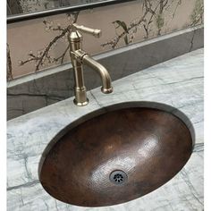 a bathroom sink that is brown and has a faucet on the counter top