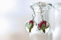 A beautiful pair of real flower earrings... these are for romantic nights and summer evenings; luxurious, velvet-petalled red roses. They are perfect, teeny tiny red rosebuds in 12mm globes. They are small, and strong, made of UV stable, extra strong crystal clear resin, with sterling silver ear wires, available in 2 lengths: extra-long hand-hammered earrings for a 40cm drop, or small 10mm drops. We spend time poring over our flowers to pair the roses up so your earrings will be as similar as na Romantic Nights, Real Flower Earrings, Pressed Flower Earrings, Hammered Earrings, Earrings Resin, Romantic Night, Rose Bud, Botanical Jewelry, Earrings Red