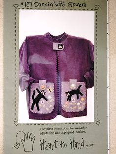 a purple jacket with black cats on it