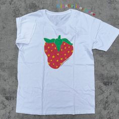 This cottagecore strawberry tee is the perfect strawberry shirt to wear wherever you go. Inspired by kidcore shirt and kidcore clothes - this original MilkDesigsShop's handdrawn illustration will surely add a pop of color to your wardrobe. It can also be a cute gift for her, cute gift for him or anyone in between as this strawberry tshirt is unisex. Available in Sizes XS, S, M, L, XL, 2XL and 3XL. *Order the next size or size after next for oversized shirt comfy look. ✨ MilkDesigns Original ✨ 100% ⭐️ PREMIUM ⭐️ Airlume combed and ringspun cotton  ✨ Light fabric ✨ Retail Unisex fit ✨ Tear away label ✨ Runs true to size ‼️ Print Size will scale up or down depending on the shirt size to keep the integrity of the print. *Sustainability Commitment: All of our products are made only upon purchas Trendy Red T-shirt With Strawberry Print, Trendy Red Strawberry Print T-shirt, Fun Cotton T-shirt With Strawberry Print, Fun Strawberry Print Short Sleeve T-shirt, Fun Short Sleeve T-shirt With Strawberry Print, Kidcore Shirt, Strawberry Tshirt, Kidcore Clothes, Cottagecore Strawberry