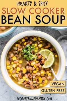 a bowl of hearty and spicy slow cooker bean soup with a lime slice on the side