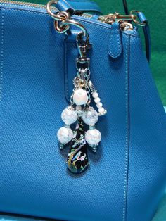 a blue purse with a chain hanging from it