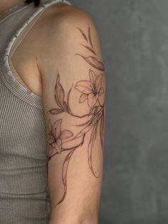 a woman with a flower tattoo on her arm