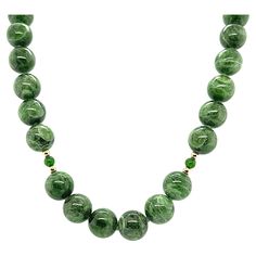 Every woman should have a strand of pearls, but not every woman (or man) has the opportunity to own a strand of rare, chrome diopside beads! This beautiful strand of 10 mm round, variegated chrome diopside beads displays gorgeous shades of basil, sage, and forest greens that makes us appreciate the beauty of nature and the outdoors. Accented with 18k yellow gold, vibrant emerald-green chrome diopside spacer beads, and finished with a high-polished 14k yellow gold clasp. A perfect accompaniment t Luxury Green Beaded Necklaces For Celebration, Cheap Green Beaded Pendant Necklace, Luxury Antique Beaded Necklace With Polished Beads, Luxury Antique Gemstone Beaded Necklaces, Luxury Green Agate Beaded Necklaces, Luxury Green Multi-stone Beaded Necklace, Cheap Vintage Beaded Necklaces With Polished Beads, South African Necklace Green, Strand Of Pearls