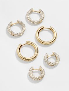 Three times the earrings, three times the layering. The Lucy Earring Set is complete with three pairs of huggie hoop earrings. Two pairs are encrusted with crystals, while the third is crafted in graphic gold. Wear a few together or break them apart for easy stacking every single day. Preppy Jewelry, Gold Girl, 18k Gold Earrings, Jewelry Accessories Ideas, Crystal Hoop Earrings, Dope Jewelry, Jewelry Lookbook, Earrings In Gold, Huggie Hoop Earrings