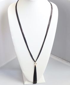 This necklace is the perfect accessory for any occasion. It's made of black rope and has a black tassel. The black color is perfect for any outfit, and the tassel adds a bit of personality. Elegant Black Beads Lariat Jewelry, Elegant Black Beaded Lariat Jewelry, Formal Costume Jewelry Chain Necklaces, Black Pendant Necklace With Chain, Formal Costume Jewelry Necklace With Adjustable Chain, Elegant 16 Inch Snake Chain Necklace, Evening Costume Jewelry Necklace With Chain, Adjustable Snake Chain Necklace For Formal Occasions, Chic Formal Necklaces With Snake Chain